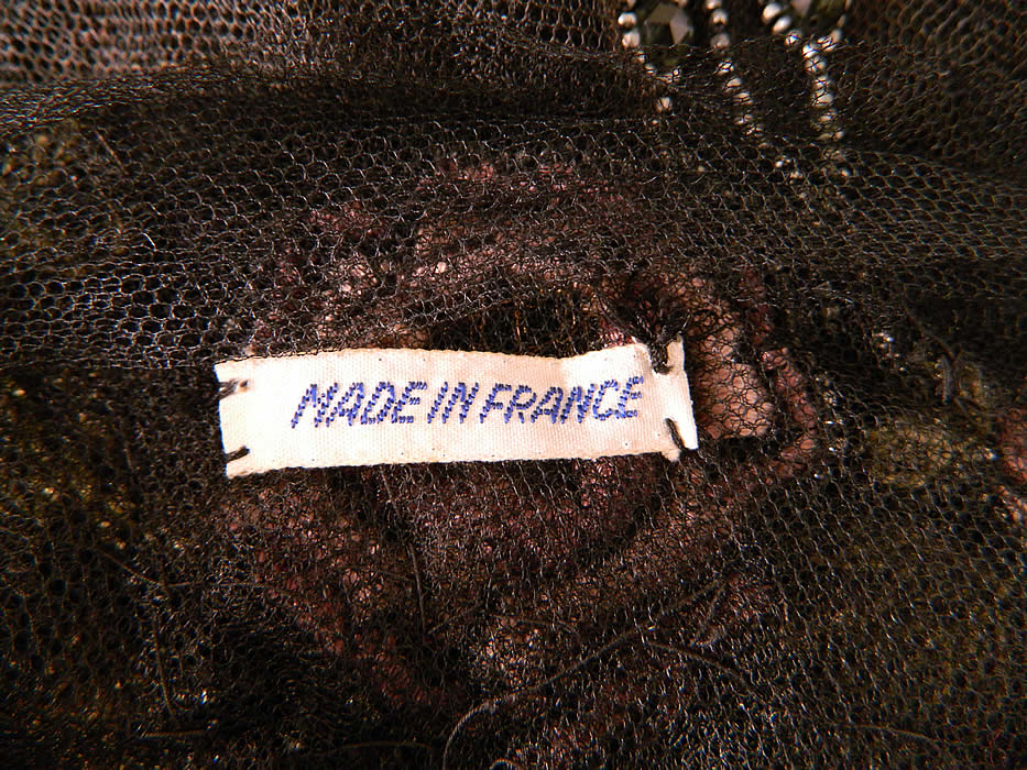 Vintage Black Net Beaded Embroidered Applique Made in France Flapper Dress. This fabulous flapper dress evening gown has a long floor length loose fitting straight shift chemise drop waist style, is sleeveless, sheer, unlined and has a "Made in France" label sewn inside. 