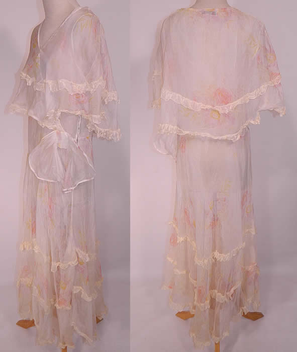 Vintage Over The Garden Wall Pink Roses  White Organdy Ruffle Shawl Collar Bias Cut Dress. This pretty garden party dress tea gown is a long floor length, bias cut, with a large ruffle flounce shawl collar capelet, sleeveless, with a ruffled handkerchief hemline skirt, side bow trim, sheer unlined and has side snap closures. 
