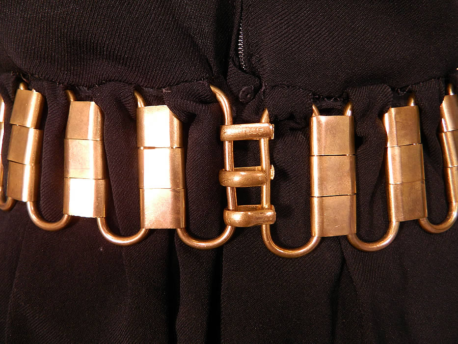 Vintage Christian Dior Paris Gold Chain Link Belted Black Cocktail Dress. This fabulous designer little black cocktail dress has a mod simple style with short sleeves, a mid length skirt and back snaps, zipper closure. 