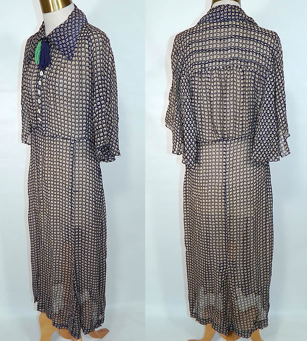 Vintage Blue & Green Silk Chiffon Novelty Print Batwing Sleeve Day Dress. This charming day dress is a long mid length, with a fold over collar, ribbon necktie trim, buttons down the front top, wide flared batwing sleeves, side snap closures and is sheer unlined. 