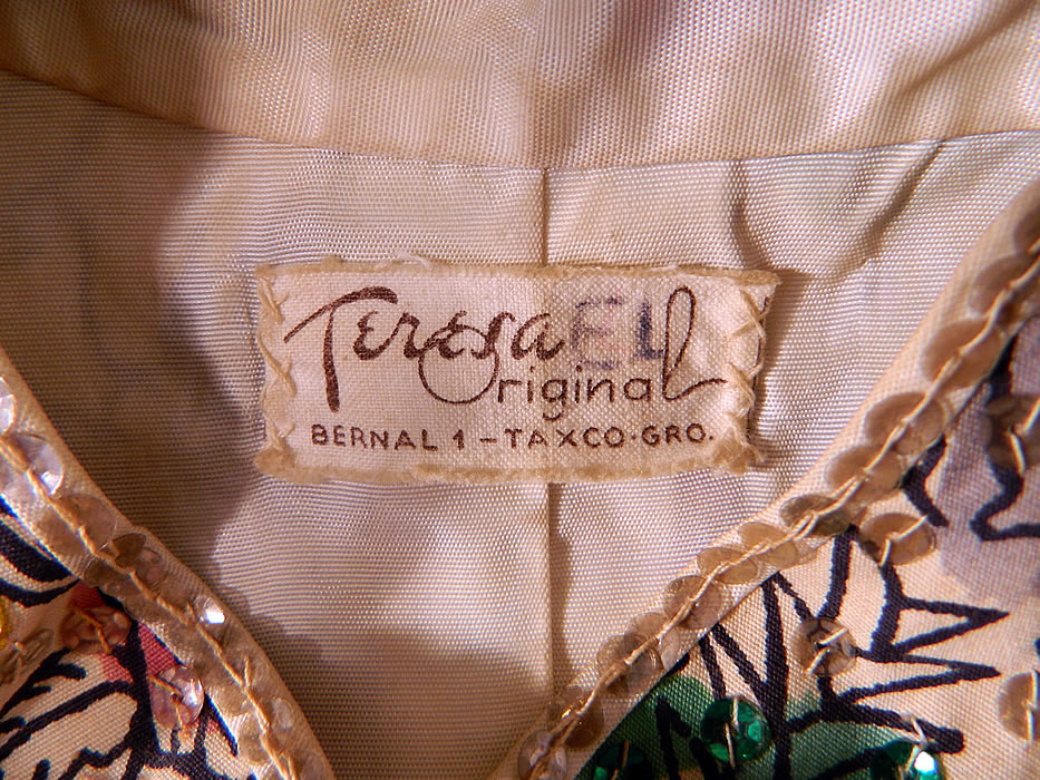 Vintage Teresa Original Taxco Mexican Figural Animals Hand Painted Sequin Jacket. This magnificent Mexican jacket has a mandarin collar, knotted button toggle closures down the front, bottom slit pockets. long sleeves and is fully lined, with a "Teresa Original Bernal 1 Taxco Gro." label sewn inside.