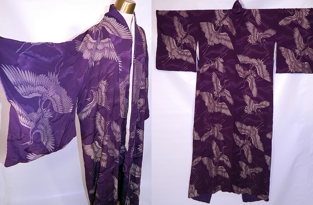 Vintage Japanese Geisha Purple Silk Silver Crane Mon Family Crest Formal Kimono. It is hand stitched, made of a dark purple silk damask brocade fabric with silver metallic thread woven into a crane bird pattern.