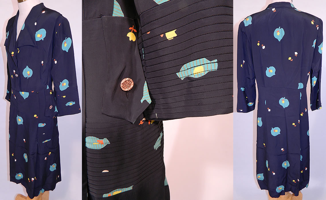 Vintage Navy Blue Rayon Heart Shape Leaf Tulip Flower Novelty Print Dress. This delightful day dress has a wide lapel collar front neckline with button trim, shoulder padding, long sleeves, pleated button flap trim sides, underarm shields sewn inside and side zipper closure. The dress is a large size measuring 43 inches long, with 44 inch hips, a 34 inch waist, 40 inch bust and 15 inch back. It is in good condition, but is missing the belt. This is truly a wonderful piece of wearable art!