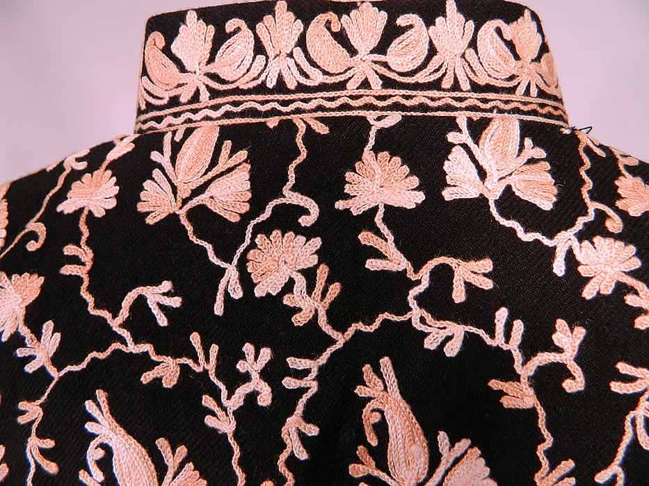 Vintage Black Wool Pink Chain Stitch Crewel Work Embroidery Ethnic Coat Jacket. The coat measures 44 inches long, with 52 inch hips, a 46 inch waist, 48 inch bust, 20 inch back and 22 inch long sleeves, with a size XL tag sewn inside. It is in excellent condition. This is truly a wonderful piece of boho wearable art!