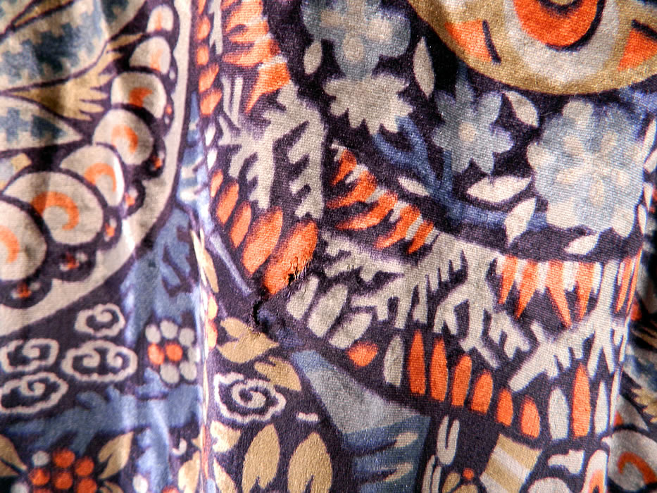 Vintage Embellished Colorful Blue Floral Print Velvet Drop Waist Flapper Dress. The dress measures 42 inches long, with 42 inch hips, a 42 inch waist, 42 inch bust and 24 inch long sleeves. It is in good condition, with a few faint age spot stains on the sheer chiffon sleeves, 3 tiny holes on the back top and some missing loose beads on the applique trim (see close-ups). This is truly a rare and exceptional quality made piece of Art Deco wearable art! 