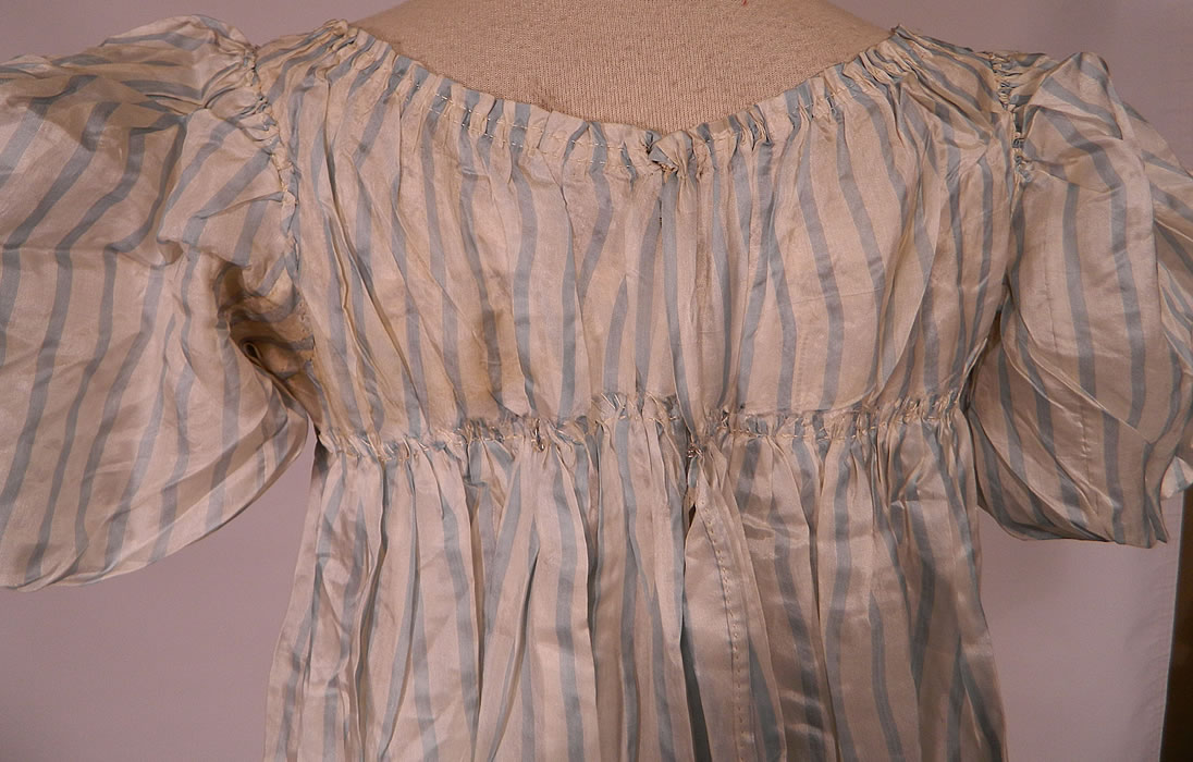 Antique Georgian Regency Era Blue & White Stripe Silk Puff Sleeve Girls Dress
The dress measures 41 inches long, with 50 inch hips, a 45 inch waist, 36 inch bust and 12 inch back.