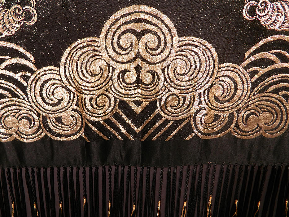 Vintage Black Silk Gold Lam&eacute; Lame Chinese Style Flapper Piano Shawl
There is a Chinese style design with the Eight Buddhist symbols of good fortune, butterflies, fish, Ji Chinese character for luck, waves of water and clouds around the border edging.