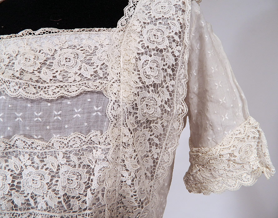 Vintage White Cotton Batiste Embroidered Polka Dot Lace Trim Dress
This lovely lace dress has a fitted waist, short skirt with rows of lace ruffle trim, squared neckline, short sleeves with lace cuffs, snap closures down the back and is sheer because it is unlined.
