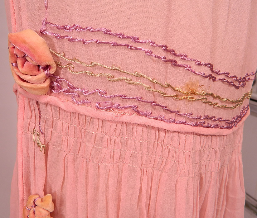 Vintage Pink Silk Chiffon Velvet Rosette Flower Trim Open Side Tunic Flapper Dress
This pretty pink dress has a tunic style with open sides, hook closures at the waist side, is loose fitting, with a drop waist, smocking around the mid section, sleeveless, a scalloped skirt hemline and is sheer, unlined. 