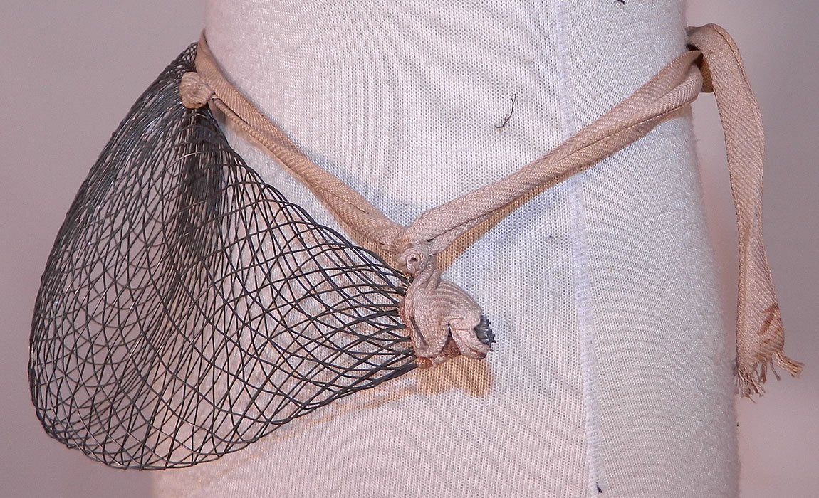 Victorian Antique Woven Wire Mesh Pillow Crescent Crinolette Bustle Pad Support
This antique Victorian era woven wire mesh pillow crescent crinolette bustle pad support dates from 1880. It is made of a woven wire mesh creating a puffed pillow crescent shaped bustle pad extender.