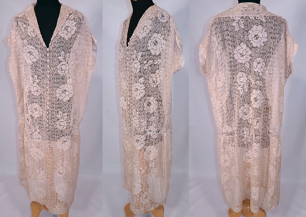 Vintage Ecru Cream Crochet Filet Lace Button Trim Drop Waist Dress
This exquisite vintage ecru cream crochet filet lace button trim drop waist dress dates from the 1920s. It is made of an off white ecru cream color sheer fishnet crochet filet lace fabric with a floral rose leaf and spiral scroll work design pattern.