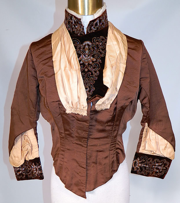 Victorian Brown Silk Velvet Bronze Beaded Bodice & Skirt Fabric Remnant Trim
This beautiful bodice top, has a high neck band collar, front insert, long fitted sleeves with rolled cuffs, a fitted waist, with back bustle tail drape, hook closures down the front and is fully lined with quality construction detailing, stays boning sewn inside. 