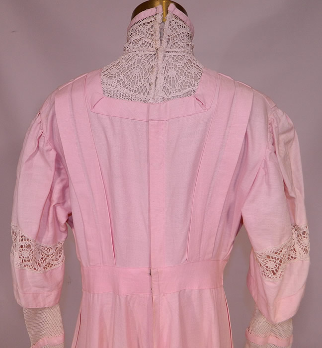 Edwardian Pink Linen White Lace Button Trim Tea Dress. 
The dress measures 57 inches long, with 38 inch hips, a 26 inch waist, 38 inch bust, 14 inch back and 25 inch long sleeves. It is in good condition, but does have some fade discoloration along the shoulders and sleeves. This is truly a wonderful piece of wearable antique textile art!