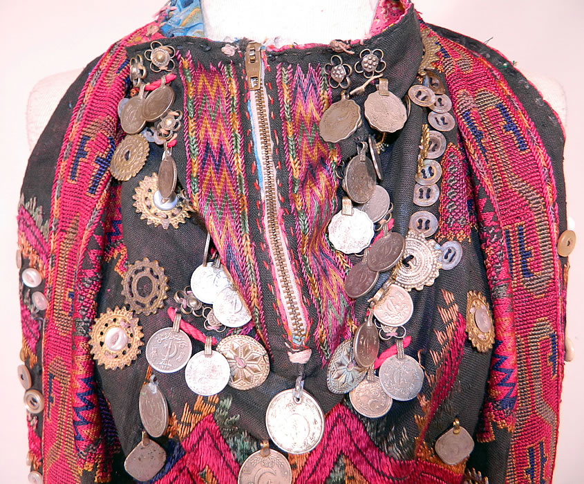 Swat Valley Pakistan Coin Beaded Embroidered Ethnic Tribal Bib Front Fabric Top
It is hand stitched, made of a heavy black cotton twill fabric, with colorful silk embroidered stitching done in geometric designs, a variety of ornamental metal buttons, beads, silver coins and amulet medallion embellishments. 