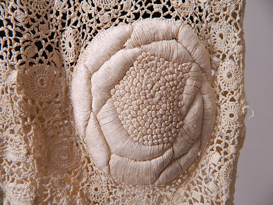 Vintage Edwardian Antique White Irish Crochet Lace Embroidered Long Coat Jacket
This lovely lace coat jacket is a long length, loose fitting with fold over flap front crochet button braided rope toggle closure, long full sleeves, a cutaway bottom front, high low skirted train back and is sheer, completely unlined. 