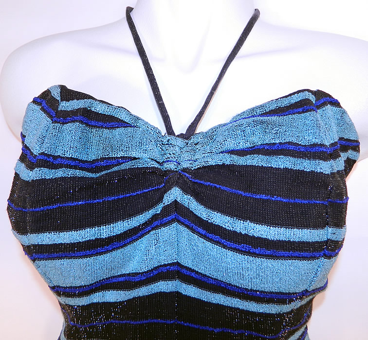 Vintage Web Foot Pinup Black & Turquoise Blue Striped Silver Glitter Knit Swimsuit
It is made of a black and turquoise blue striped silver glitter flecks stretch knit fabric. This sexy pinup bombshell bathing suit swimsuit has an adjustable neck tie strap halter top, with a sweetheart neckline, drawstring side gathering on the bottom shorts, a zipper back closure and stays, boning, built in shelf bra lining sewn inside.