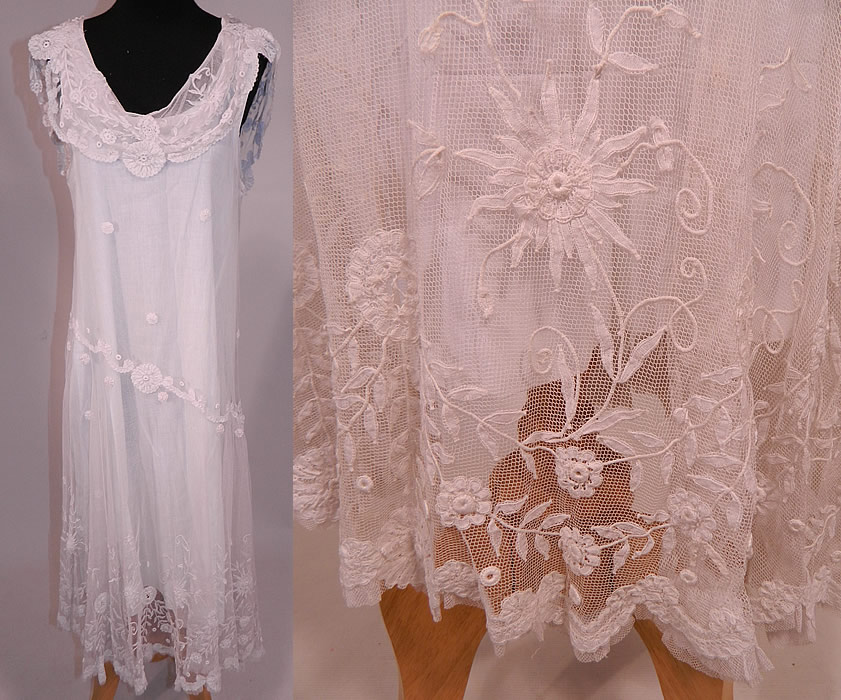 Vintage White Net Princess Tape Lace Applique Embroidered Drop Waist Dress & Slip
This exceptional vintage white net princess tape lace appliqué embroidered drop waist dress and slip dates from the 1920s. It is made of a white sheer cotton net princess lace fabric, with tape lace appliqué embroidery work done in a floral vine leaf, spiral, scroll work, polka dot designs.