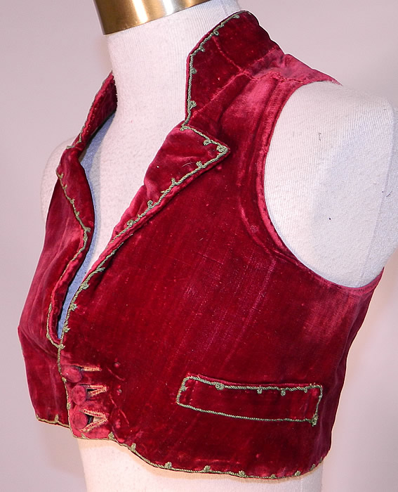 Vintage Regional Folk Costume Spanish Soutache Embroidery Red Velvet Vest
This handsome men's Spanish regional folk costume Spencer style waistcoat sleeveless short bolero crop top vest has 3 velvet buttons at the bottom for closure, front slit pockets, flared drape tail back bottom with gold button trim and lined in a homespun linen fabric.