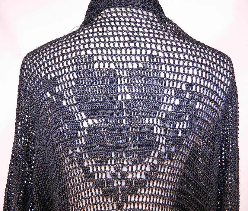 Vintage Black Silk Knit Crochet Lace Fringe Shawl Long Coat Boho Sweater Jacket
This beautiful boho chic coat has a loose fitting, long floor length style with an open front, no closure. long full sleeves with fringe trim cuffs, a fringed bottom skirt hem and is sheer, completely unlined.