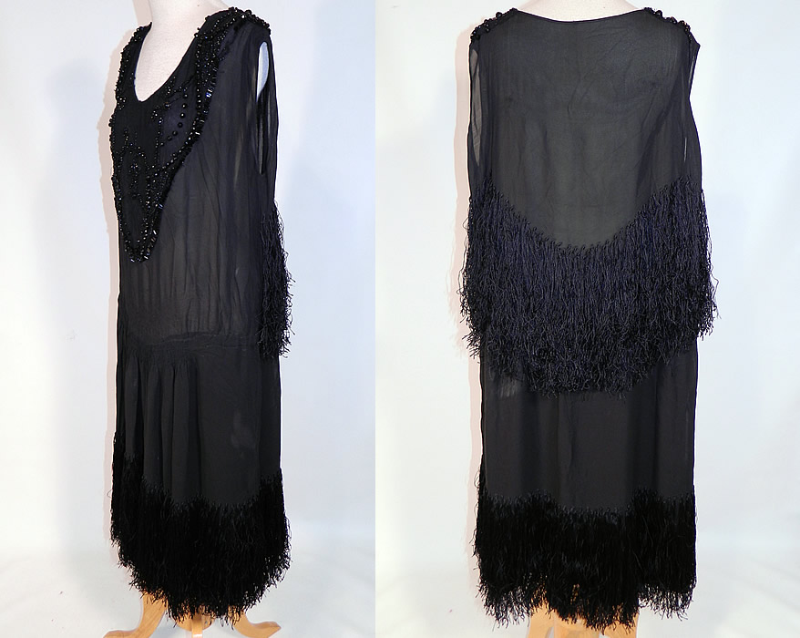 Vintage Art Deco Black Silk Jet Beaded Fringed Flapper Drop Waist Dress
This fabulous flapper dress has a loose fitting drop waist style, with ruched smocking around the mid section, sleeveless, with wide open arm holes, a rounded low front scoop neckline and is lined.