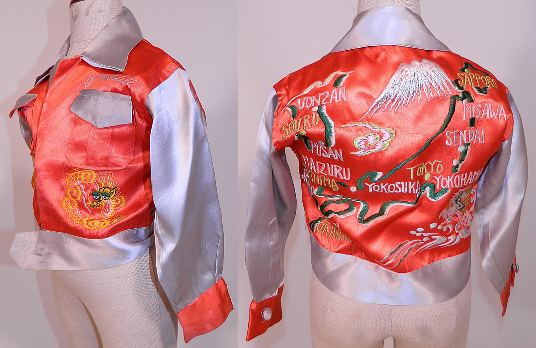 Vintage WWII Japan Souvenir Tour Jacket Child's Shirt Satin Embroidered Map
This child's size small souvenir tour jacket has a shirt style, with a fold over collar, 2 front breast pockets with the name "J. Mitchell" embroidered above it, long sleeves with button cuffs, a fitted waistband with button closures down the front and is unlined.