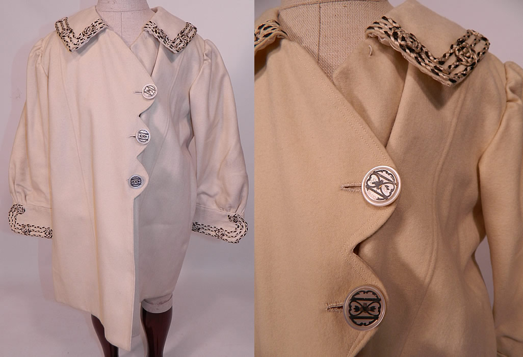Edwardian White Wool Silver Soutache Braided Trim Childs Winter Coat
This antique Edwardian era white wool silver soutache braided trim child's winter coat dates from 1910. It is made of a white fine soft wool fabric, with silver and white silk soutache braided rope trim edging with knotted rosette accents.