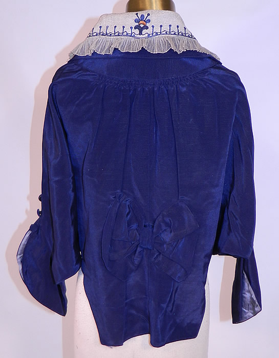 Titanic Era Edwardian Blue Silk Dolman Sleeve Short Crop Coat Bolero Jacket

This beautiful blue short crop coat bolero jacket has long flared batwing dolman style sleeves with button trim, a bow trim back drape, decorative fold over collar, toggle button front closure and is silk lined with weights sewn on the bottom back hem. 