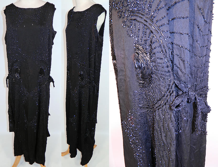 Vintage Art Deco Black Silk Jet Beaded Flapper Drop Waist Side Tie Dress Evening Gown
This vintage Art Deco black silk jet beaded flapper drop waist side tie dress evening gown dates from the 1920s. It is made of a black silk fabric, with jet bead work done in an amazing Art Deco circular, striped, sunburst designs.