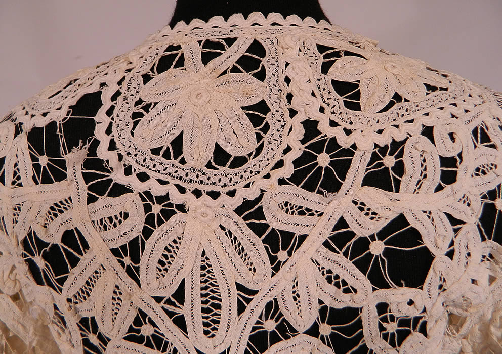 Vintage Edwardian Antique Cream Battenburg Crochet Tape Lace Tail Coat Jacket
The coat measures 31 inches long, with 34 inch hips, a 24 inch waist, 34 inch bust, 14 inch back and 24 inch long sleeves. It is in good condition, with only a few small breaks in the connecting brides and some faint tiny age spotting (see close-ups). This is truly an amazing, exceptional, quality made piece of wearable antique lace art!