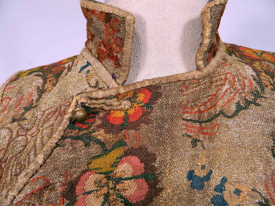 Antique 19th Century Chinese Tibetan Gold Lame Brocade Sleeveless Monks Vest Lam&eacute;
This exquisite sleeveless short robe monks vest top has a mandarin style high collar, round carved brass button toggle closures along the side, cotton binding wrapped fabric trim edging and is fully lined in a blue cotton fabric. 
