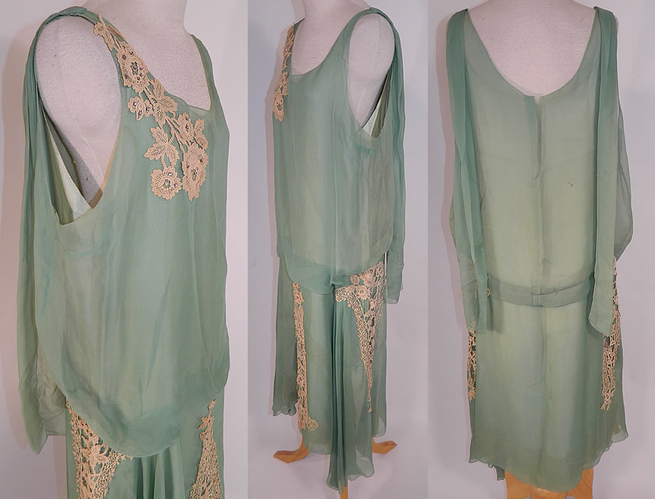 Vintage Mint Green Silk Chiffon Lace Applique Rhinestone Trim Drop Waist Dress
This fabulous flapper dress is loose fitting, with a drop waist, sleeveless top, an uneven asymmetrical handkerchief hemline skirt, scarf panels hanging down from the back shoulders and is fully lined in a mint green silk slip sewn inside.