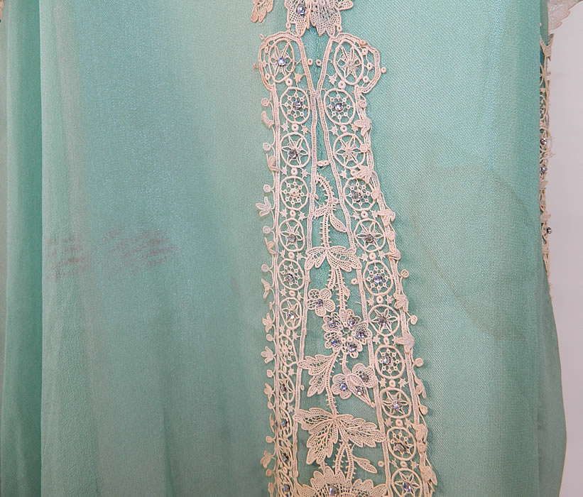 Vintage Mint Green Silk Chiffon Lace Applique Rhinestone Trim Drop Waist Dress
The dress measures 47 inches long, with 38 inch hips, a 34 inch waist and 36 inch bust. It is in good as-is condition, with some faint discoloration under the arms and two stains on the front skirt (see close-up). This is truly a wonderful piece of Art Deco wearable art! 