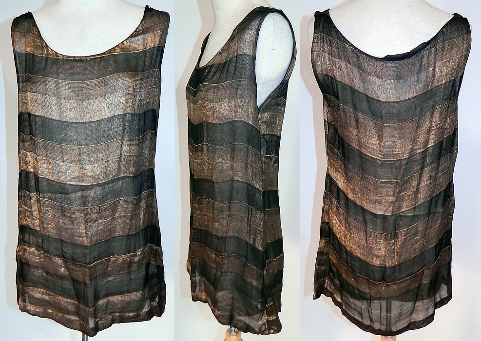 Vintage Art Deco Black & Gold Lame Silk Stripe Flapper Tunic Top Dress Lamé
This vintage Art Deco black and gold lamé silk stripe flapper tunic top dress dates from the 1920s. It is made of a black and gold lamé sheer silk chiffon fabric with a striped pattern design. This fabulous flapper tunic top style sleeveless mini dress is sheer and unlined.