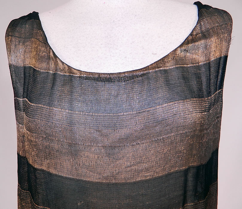 Vintage Art Deco Black & Gold Lame Silk Stripe Flapper Tunic Top Dress Lamé
The dress measures 26 inches long, with a 34 inch waist and 32 inch bust. It is in good condition, with only some tarnish discoloration. This is truly a wonderful piece of wearable Art Deco textile art!