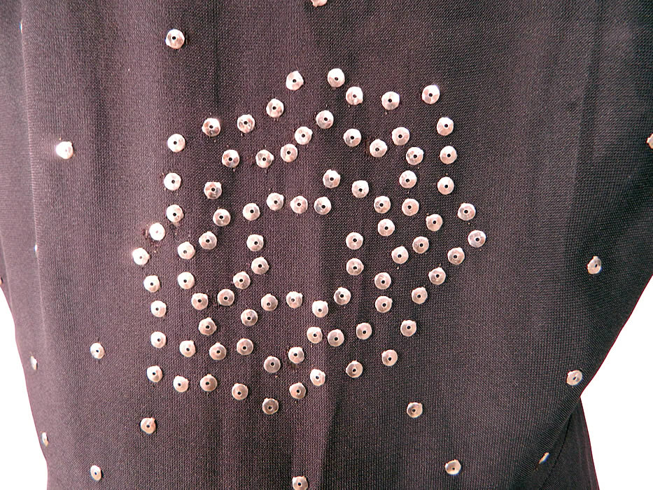Vintage Black Silk Silver Metal Sequin Studded Beaded Cocktail Dress
The dress measures 42 inches long, with 36 inch hips, a 26 inch waist and 36 inch bust. It is in good condition, with only a few tiny pin hole pulls on the back sequins (see close-up). This is truly a wonderful piece of wearable art! 