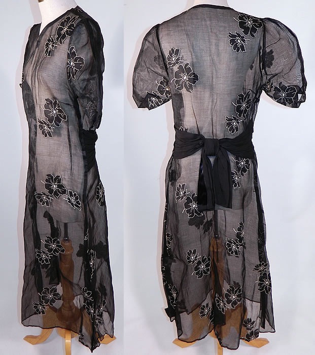 Vintage Black & White Poppy Flower Applique Organdy Balloon Sleeve Day Dress
This pretty poppy delightful day dress has billowing balloon style short puffy sleeves, a black silk sash belted bow back, short mid length skirt, side and shoulder snap closures and is sheer completely unlined. 