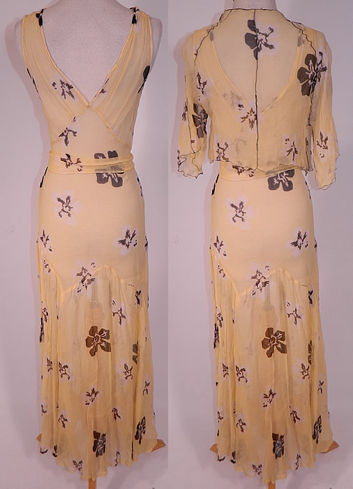 Vintage Yellow Silk Chiffon Black Floral Print Belted Bias Cut Dress & Jacket
The dress measures 57 inches long, with 36 inch hips, a 28 inch waist and 36 inch bust. Included is a matching fabric short cropped jacket, with decorative black stitching details, an open front with no closure, 3/4 length flared sleeves and is sheer, unlined. The jacket measures 13 inches long, with a 24 inch waist and 36 inch bust. It is in good condition. This is truly a wonderful piece of wearable art! 
