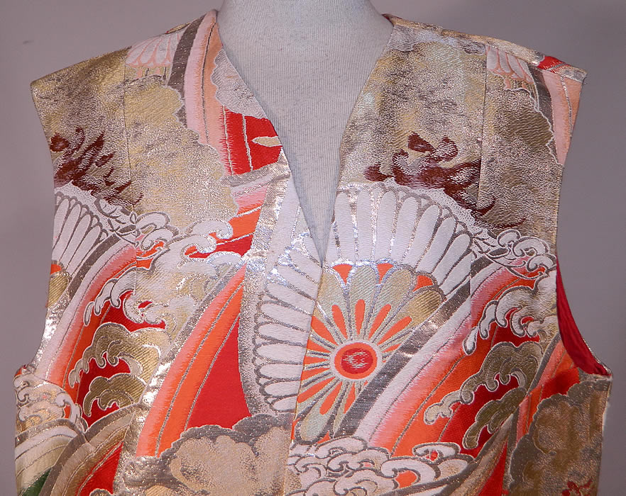 Vintage Japanese Gold Silk Lamé Lame Ocean Waves Obi Fabric Sleeveless Vest Jacket
This elegant evening vest sleeveless jacket is a long floor length, with a loose fitting style, side skirt slits for easy movement, an open front with no closure and is fully lined in a reddish orange silk fabric inside.