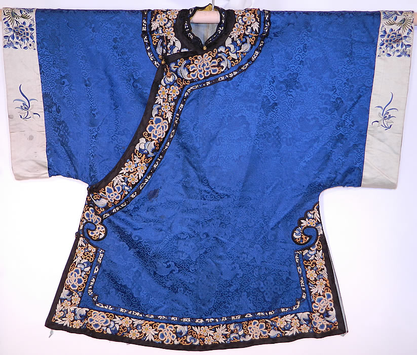 Antique Chinese Blue Silk Damask Brocade Forbidden Stitch Embroidered Trim Robe
There is a black silk trim collar and edging with beautifully hand embroidered, forbidden stitch Peking knot peony flowers and gold couching work accents. 