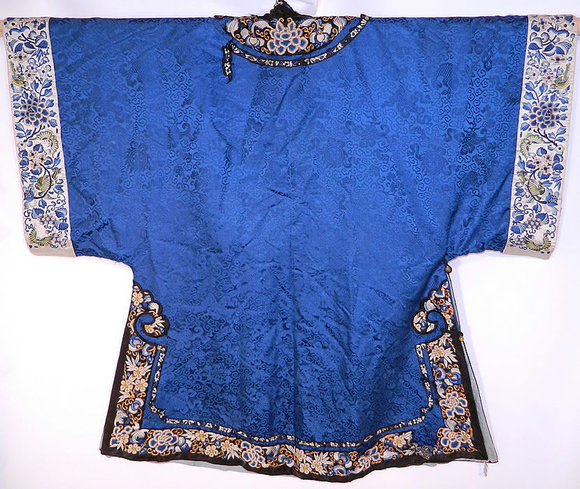 Antique Chinese Blue Silk Damask Brocade Forbidden Stitch Embroidered Trim Robe
There are blue silk embroidered sleeve cuff bands with green birds and butterflies. This magnificent Manchu womens robe has carved round brass buttons, silk loop toggles for closure along the side, long full sleeves with wide cuffs, side skirt vents and is fully lined inside.