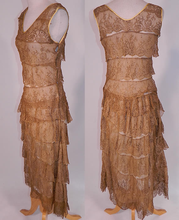 Vintage Gold Metallic Lam&eacute; Lame Lace Layered Tiered Ruffle Tango Flapper Dress 
This fabulous flapper, tango dance style fitted dress is sleeveless, with V necklines trimmed with gold silk trim edging, side snap closures and is lined in an off white cotton mesh net fabric with layers of gold lace trim ruffles tiered down. 