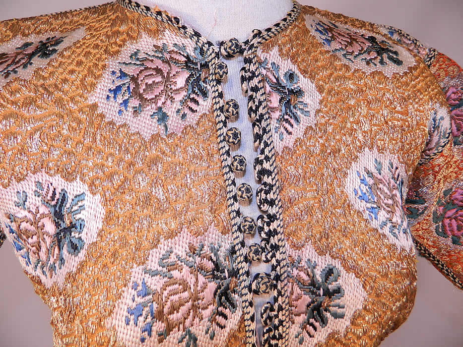 Antique Bukhara Uzbekistan Gold Lamé Lame Brocaded Childs Chapan Coat
This exquisite charming child's chapan caftan coat robe has a black & white silk braided rope trim edging, with knotted round button toggle loop closures down the front, long full sleeves and is fully lined in a lilac color silk fabric.