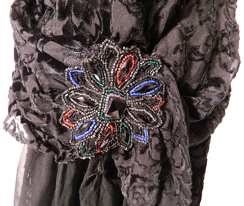 Vintage Silver Lace Black Burnout Voided Velvet Silk Drop Waist Flapper Dress
There is a silver lam&eacute; lace front top panel insert, with black silk ruffle edging along the neckline and colorful beaded appliqu&eacute; trim accent on the side hip.