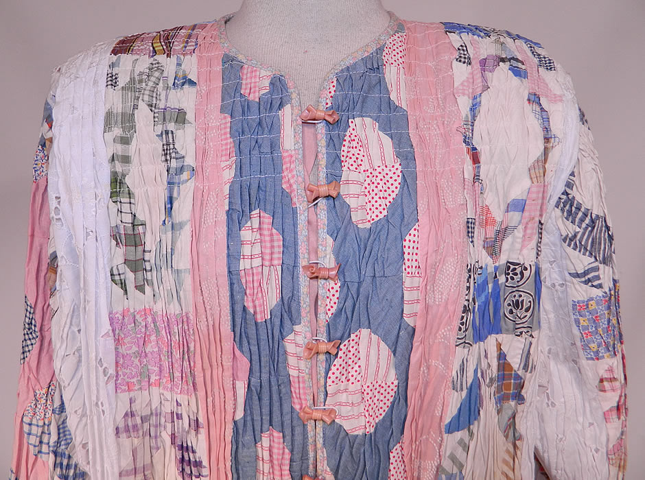 Vintage Antique Calico Crazy Quilt Patchwork Lace Smocking Ruched Pintuck Coat
There is white eyelet lace fabric inserts. This unique quilted art coat jacket is loose fitting, a long length, with a full boxy style, broad shoulders, long full sleeves, cute pink bow button closures down the front and is fully lined.