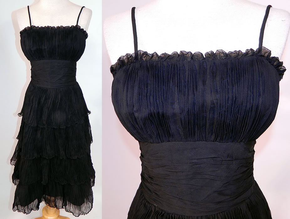 Vintage Suzy Perette NY Label Black Silk Pleated Ruffle Spaghetti Strap Cocktail Dress
This vintage Suzy Perette NY label black silk pleated ruffle spaghetti strap cocktail dress dates from the 1950s. It is made of a black silk fabric, with fine pleated details and ruffle accents.