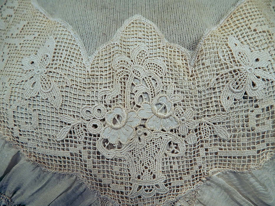 Vintage Victorian Style Ecru Cream Cotton Irish Crochet Filet Lace Applique Trim Blouse
This beautiful boho blouse has a high neck lace collar, with a sheer chiffon panel open cut out front neckline, long tapered sleeves with sheer silk ruched gathering along the sides, fitted lace cuffs with snap closures, a back zipper closure and is unlined. 