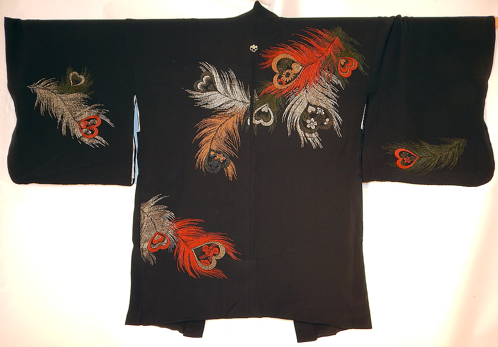 Vintage Japanese Family Crest Mon Black Silk Metallic Peacock Feather Haori Kimono
This unique haori kimono style short jacket has a single mon emblem family crest on the back neck and is fully lined. The kimono measures 35 inches long, with 18 inch long kimono sleeves and is 54 inches across the shoulders, sleeves.