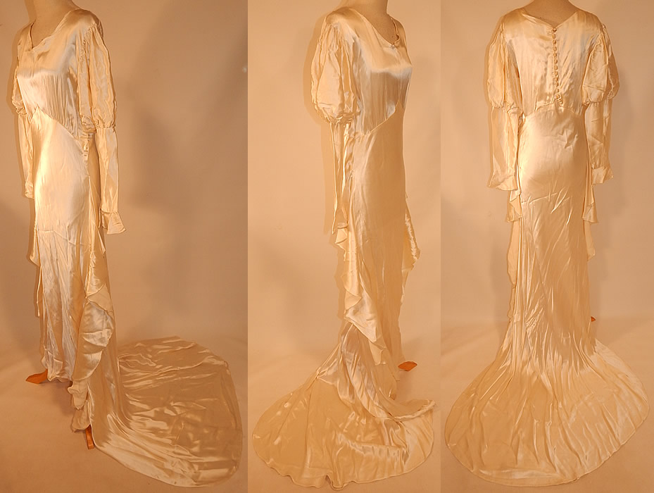 Vintage White Silk Satin Bias Cut Wedding Gown Dress Long Train Skirt
The dress measures 57 inches long in the front, 80 inches long in the back with train, 40 inch hips, a 30 inch waist, 36 inch bust and 19 inch long sleeves.