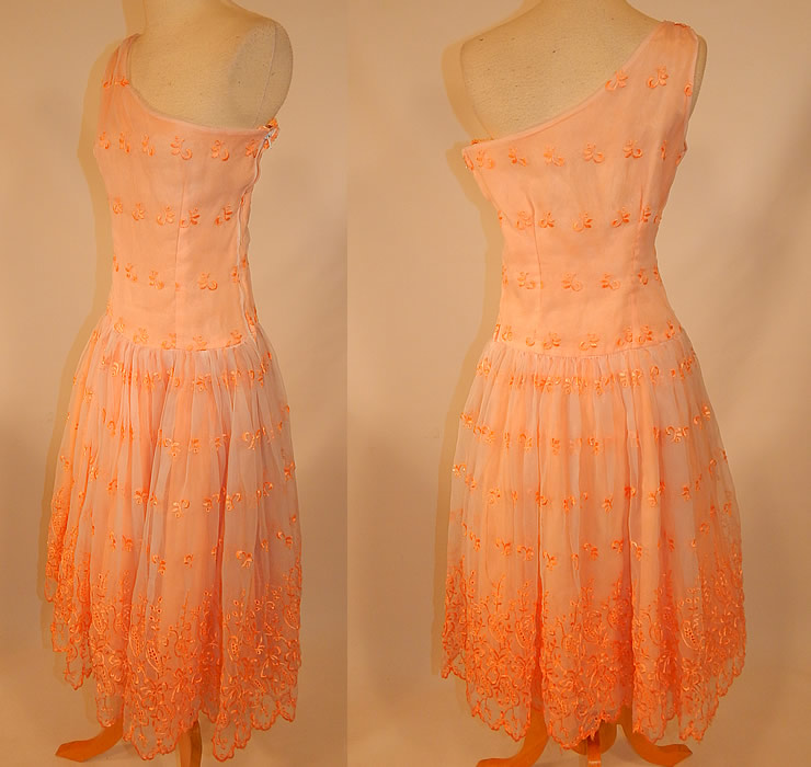 Vintage Peach Pastel Organdy Eyelet Embroidered One Shoulder Circle Skirt Dress
This pretty peach party dress has a one shoulder sleeveless style, with a long waist, full circle skirt, side zipper closure and is fully lined.