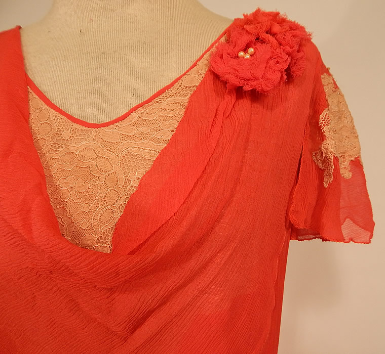 Vintage Red Silk Chiffon Cream Lace Floral Trim Belted Bias Cut Dress
This beautiful bias cut dress is a shorter mid length, with a cowl drape necklines, a red chiffon flower pearl beaded trim on the shoulder, fluttery short cap sleeves, a matching fabric belt with silver metal buckle clasp closure and is fully lined. 
